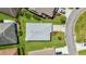 Aerial view of a well-maintained house with a gray roof, situated on a beautifully landscaped lot at 3203 Islawild Way, The Villages, FL 32163