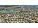 Find the house from an aerial view in a neighborhood with a lake at 3203 Islawild Way, The Villages, FL 32163