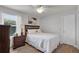 Cozy bedroom with neutral tones, ceiling fan, and wood-look flooring at 3203 Islawild Way, The Villages, FL 32163