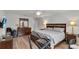 Large bedroom with wood floors, tv, exercise bike, and ensuite bathroom at 3203 Islawild Way, The Villages, FL 32163