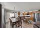 Dining area featuring a large wooden table, seating for six, and a sliding glass door at 3203 Islawild Way, The Villages, FL 32163