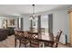Dining area featuring a large wooden table, seating for six, and hardwood flooring at 3203 Islawild Way, The Villages, FL 32163