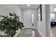Bright foyer with wood-look flooring, decorative rug, and stylish front door with glass accent at 3203 Islawild Way, The Villages, FL 32163