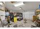Spacious garage with overhead lighting, a golf cart and ample storage space at 3203 Islawild Way, The Villages, FL 32163