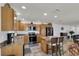 Well-lit kitchen features stainless steel appliances, an island, and barstool seating at 3203 Islawild Way, The Villages, FL 32163