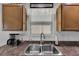 Bright kitchen sink area with stainless steel sink, window and 'Give Thanks' sign at 3203 Islawild Way, The Villages, FL 32163