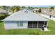 Well-maintained home featuring a screened lanai and an outdoor grill, perfect for enjoying the backyard at 3203 Islawild Way, The Villages, FL 32163