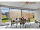 Relaxing screened porch featuring a dining area and exterior roll-down sun shades at 3203 Islawild Way, The Villages, FL 32163
