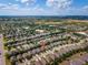 Expansive aerial view of a residential community with tree-lined streets and well-maintained homes at 3654 Limestone St, Clermont, FL 34711