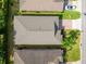 Aerial shot of a home's roof and driveway, set in a neighborhood with mature trees at 3654 Limestone St, Clermont, FL 34711