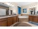Bathroom featuring a soaking tub, double vanity sinks, and tiled flooring at 3654 Limestone St, Clermont, FL 34711