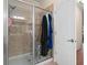 Bathroom with a glass-enclosed shower featuring a rain shower head and tiled walls at 3654 Limestone St, Clermont, FL 34711