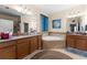 Bathroom featuring a soaking tub, double vanity sinks, and tiled flooring at 3654 Limestone St, Clermont, FL 34711