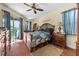 Well-lit bedroom boasts a ceiling fan, a sliding glass door and a charming music station at 3654 Limestone St, Clermont, FL 34711