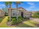 Charming home with a well-manicured lawn, mature palm trees, and an attached two-car garage at 3654 Limestone St, Clermont, FL 34711
