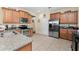 Well-lit kitchen with stainless-steel appliances, tile floors, and spacious countertops at 3654 Limestone St, Clermont, FL 34711