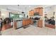 Spacious kitchen with stainless steel appliances, tile floors, granite countertops, and view to dining area at 3654 Limestone St, Clermont, FL 34711
