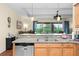 Well-equipped kitchen featuring stainless appliances, granite counters, tile flooring, and breakfast bar at 3654 Limestone St, Clermont, FL 34711