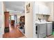 View of a laundry area from a hallway, complete with a washer, dryer, and storage cabinets at 3654 Limestone St, Clermont, FL 34711