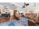 Open-concept living room featuring wood floors, comfortable furniture, and access to the kitchen and dining area at 3654 Limestone St, Clermont, FL 34711