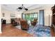 Spacious living room featuring hardwood floors, comfortable seating, and sliding glass doors to the lanai at 3654 Limestone St, Clermont, FL 34711