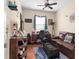 Cozy home office with a leather couch, desk, and ceiling fan, offering a comfortable workspace at 3654 Limestone St, Clermont, FL 34711