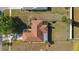 Aerial view of a well-maintained home with a brown roof, green lawn and fenced backyard at 36545 Scottsdale Dr, Grand Island, FL 32735