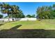 Large fenced backyard features a white vinyl fence for privacy and beautiful palm trees at 36545 Scottsdale Dr, Grand Island, FL 32735