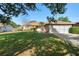 Single-story home features a well-kept lawn, mature trees, and a classic brick exterior with a two-car garage at 36545 Scottsdale Dr, Grand Island, FL 32735
