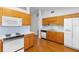 Functional kitchen with wooden cabinets, white appliances, and a practical layout at 36545 Scottsdale Dr, Grand Island, FL 32735