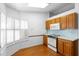 Charming kitchen area with a bright window, light cabinets, and wooden floor at 36545 Scottsdale Dr, Grand Island, FL 32735