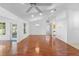 Inviting living room boasts beautiful wood floors, a ceiling fan, and access to the backyard at 36545 Scottsdale Dr, Grand Island, FL 32735
