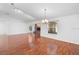 Spacious living room featuring gleaming wood floors and a classic brick fireplace at 36545 Scottsdale Dr, Grand Island, FL 32735