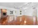 Spacious living room with wood floors, brick fireplace, ceiling fans, and track lighting for a modern feel at 36545 Scottsdale Dr, Grand Island, FL 32735