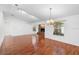 Bright living room with wood floors and a cozy brick fireplace that opens to views of the backyard at 36545 Scottsdale Dr, Grand Island, FL 32735
