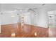 Open living room with beautiful wood floors, recessed lighting, and ceiling fans, leading to kitchen and bedrooms at 36545 Scottsdale Dr, Grand Island, FL 32735