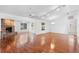 Bright living room featuring a brick fireplace, wood floors, and ample natural light at 36545 Scottsdale Dr, Grand Island, FL 32735