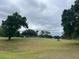 Expansive backyard with clear views of the blue sky and mature landscaping at 3708 Fairfield Dr, Clermont, FL 34711