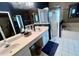 Bright bathroom featuring double vanity, shower, and soaking tub with blue accent wall and stripe wallpaper at 3708 Fairfield Dr, Clermont, FL 34711