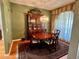Formal dining room with hardwood floors, china cabinet, and elegant chandelier at 3708 Fairfield Dr, Clermont, FL 34711