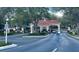 View of community entrance gate with manicured landscaping and signage at 3708 Fairfield Dr, Clermont, FL 34711