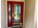 The elegant front door features ornate glass and a bright red finish at 3708 Fairfield Dr, Clermont, FL 34711