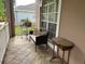 Relaxing front porch area with bench seating, side table, and pleasant view at 3708 Fairfield Dr, Clermont, FL 34711