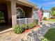 Charming front porch area with brick walkway and American flag waving in the breeze at 3708 Fairfield Dr, Clermont, FL 34711