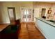 Open concept kitchen space with wood flooring, white cabinets, and access to living areas at 3708 Fairfield Dr, Clermont, FL 34711