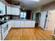 A well-lit kitchen featuring white cabinets, wood flooring and ample counter space at 3708 Fairfield Dr, Clermont, FL 34711