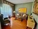 Living room featuring hardwood floors, comfortable seating, and bright window at 3708 Fairfield Dr, Clermont, FL 34711