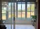 Bright sunroom with tile flooring and windows overlooking the green backyard at 3708 Fairfield Dr, Clermont, FL 34711