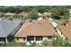 An aerial view shows the home's roof, screened lanai, and well-manicured backyard at 3828 Arbordale Ct, Leesburg, FL 34748