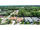 Aerial view of home with mature landscaping, surrounded by lush greenery and neighborhood streets at 3828 Arbordale Ct, Leesburg, FL 34748